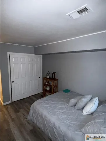 a bedroom with a bed and a closet