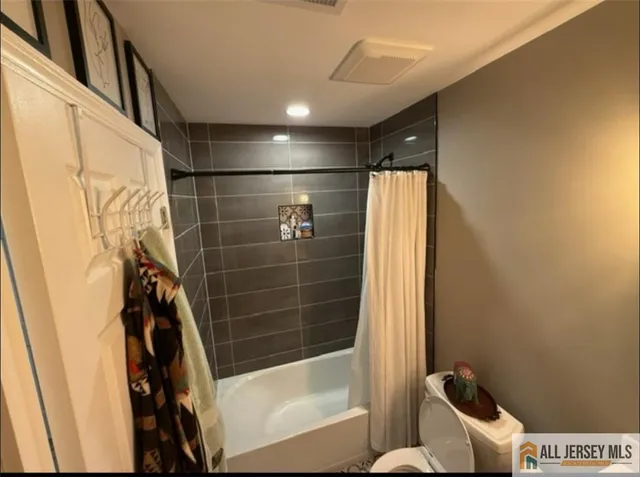 a bathroom with a bathtub and toilet