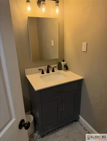 a bathroom with a sink and a mirror