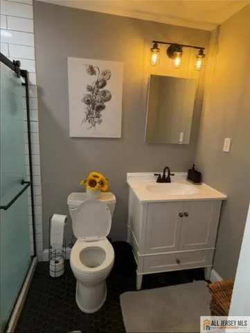 a white toilet sitting next to a bathroom sink