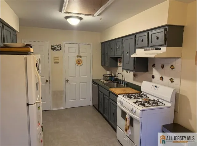 a kitchen with stainless steel appliances granite countertop a stove and a refrigerator
