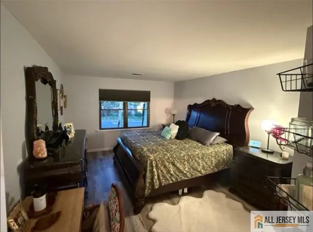 a bedroom with a bed window and dresser