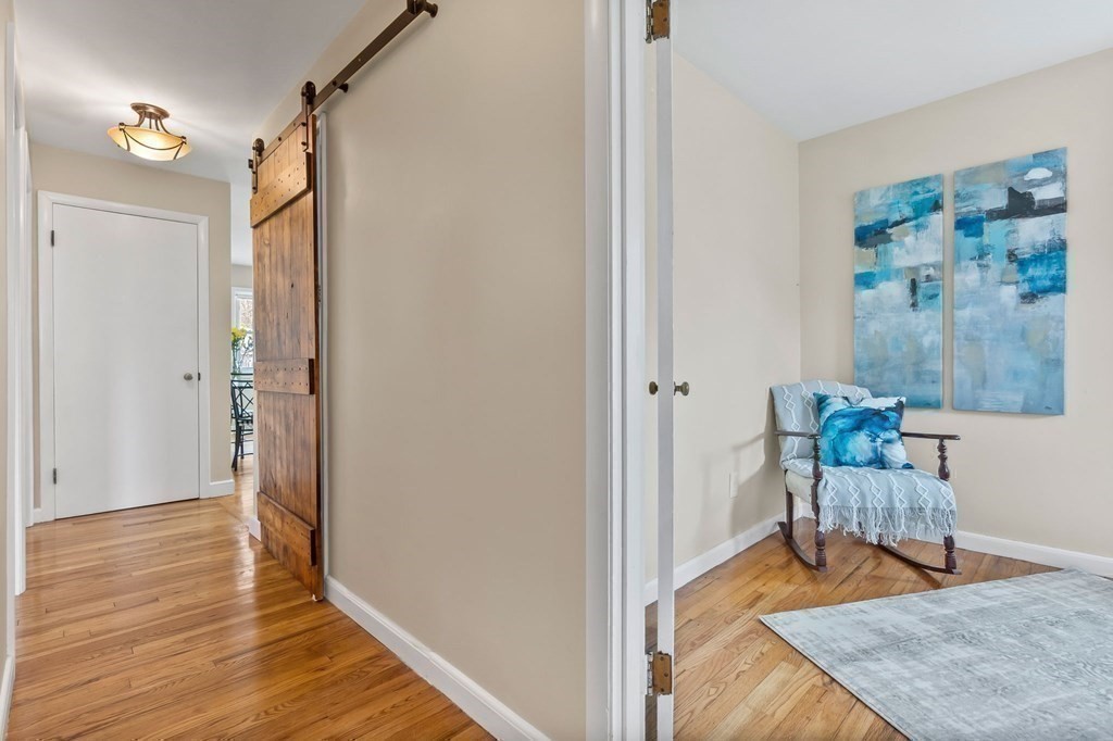 4 Claire Road Amesbury, MA 01913 - Photo 13 of 26 a view of a hallway with wooden floor and a bathroom