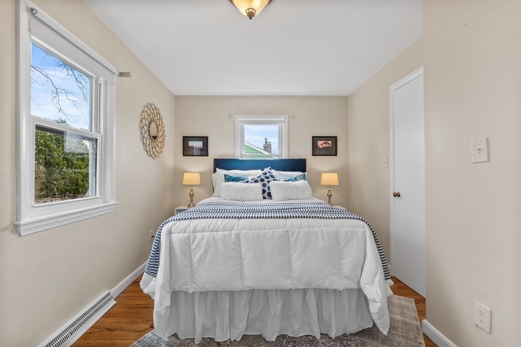 4 Claire Road Amesbury, MA 01913 - Photo 15 of 26 a bedroom with a bed a window and painting on the wall