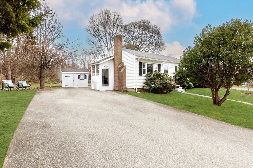 4 Claire Road Amesbury, MA 01913 - Photo 2 of 26 a front view of a house with a garden and trees