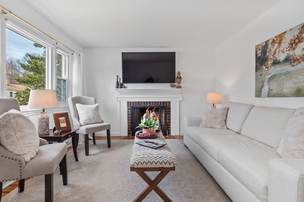 4 Claire Road Amesbury, MA 01913 - Photo 7 of 26 a living room with furniture a flat screen tv and a fireplace