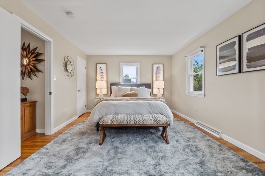 4 Claire Road Amesbury, MA 01913 - Photo 10 of 26 a bed room with a bed and painting on the wall