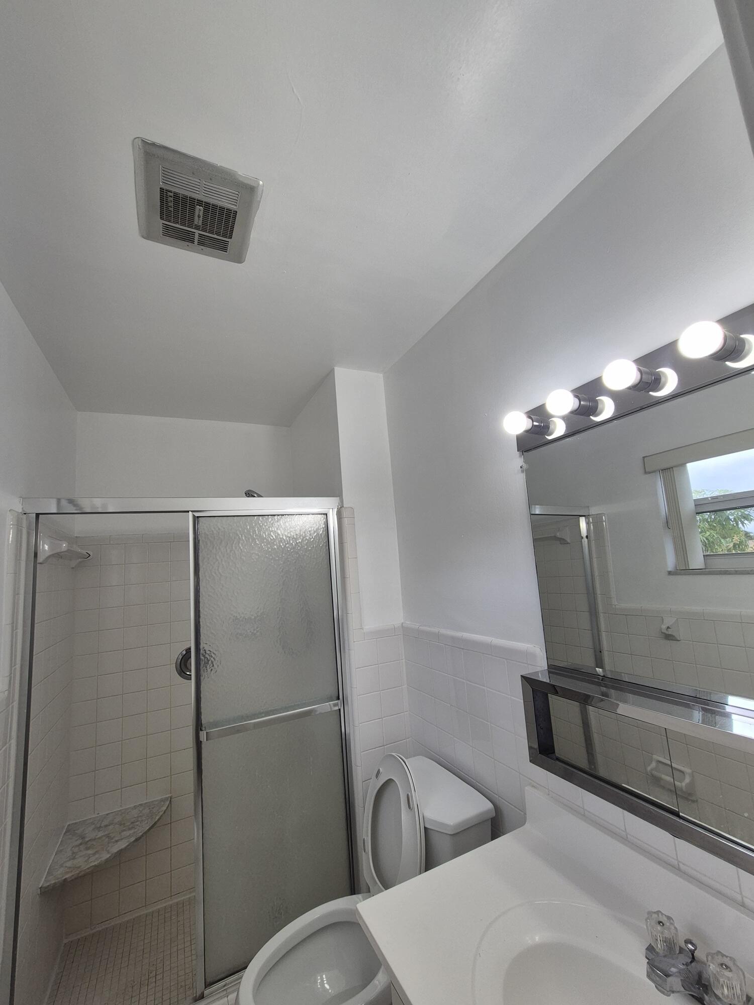 3709 Tyler Street Hollywood, FL 33021 - Photo 7 of 14 a bathroom with a toilet a sink and mirror