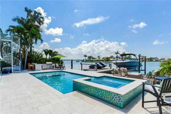 a swimming pool with outdoor seating and yard