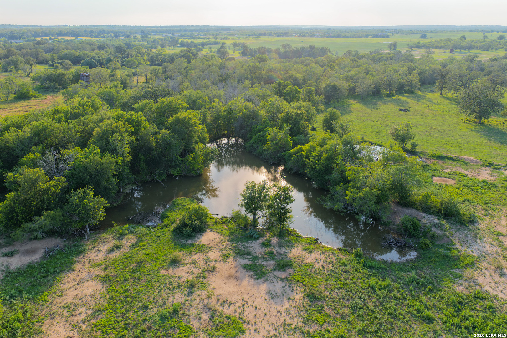 430 Watts Road Kingsbury, TX 78638 - Photo 4 of 37 a view of a lake with green field