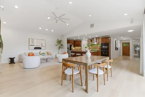 a living room with furniture and kitchen view