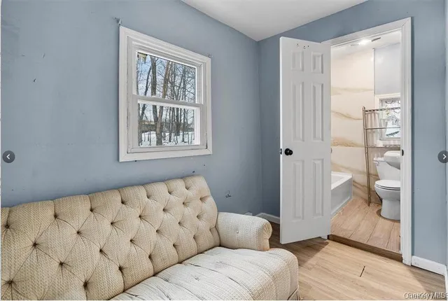 a living room with a large window and a rug