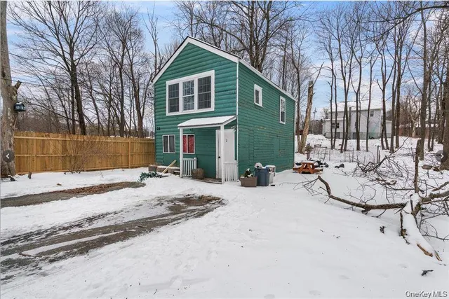 a view of a house with a yard and sitting area