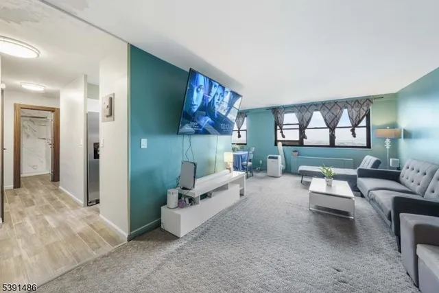 a living room with furniture and a large window