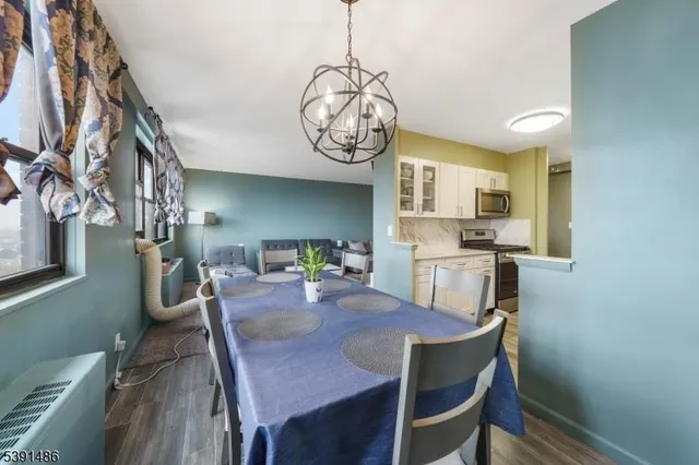 a view of a dining room with furniture wooden floor and a chandelier