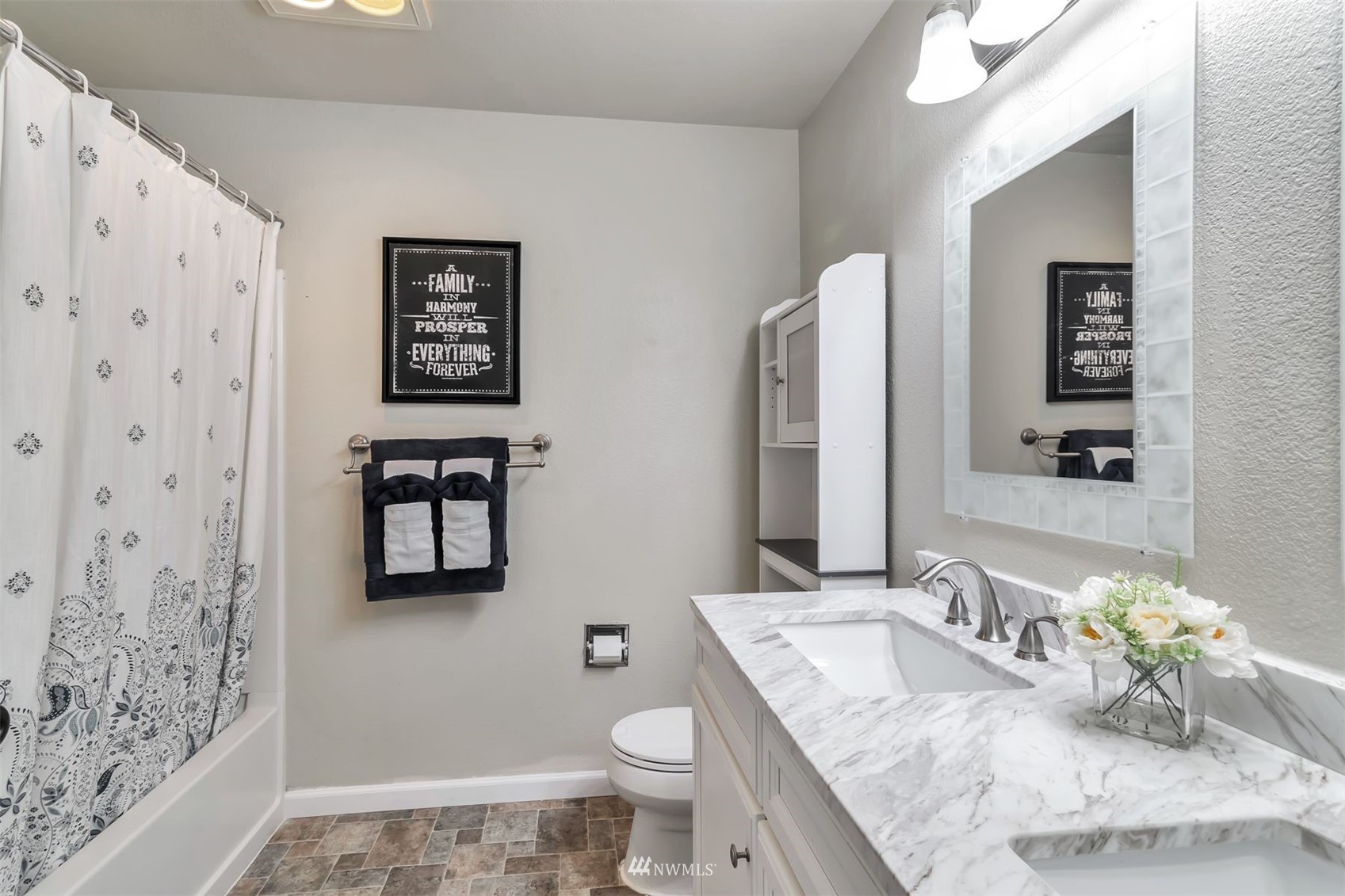 18910 Bothell Everett Highway, Unit O1 Bothell, WA 98012 - Photo 13 of 15 a bathroom with a granite countertop sink mirror vanity and toilet