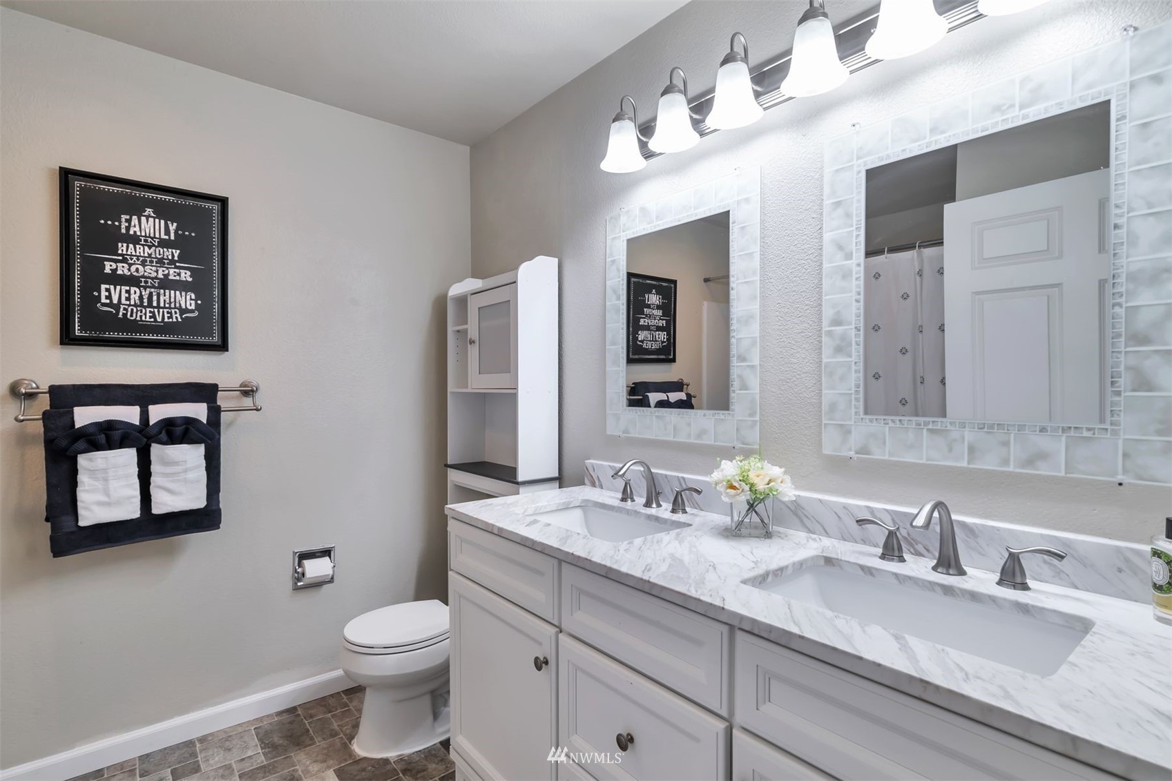 18910 Bothell Everett Highway, Unit O1 Bothell, WA 98012 - Photo 14 of 15 a bathroom with a toilet sink double vanity and mirror