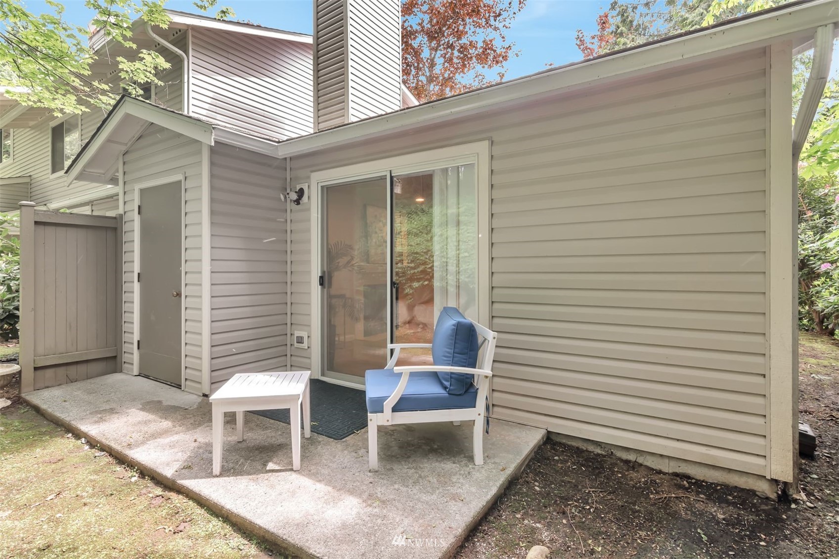 18910 Bothell Everett Highway, Unit O1 Bothell, WA 98012 - Photo 3 of 15 a view of a patio with a table and chairs and potted plants