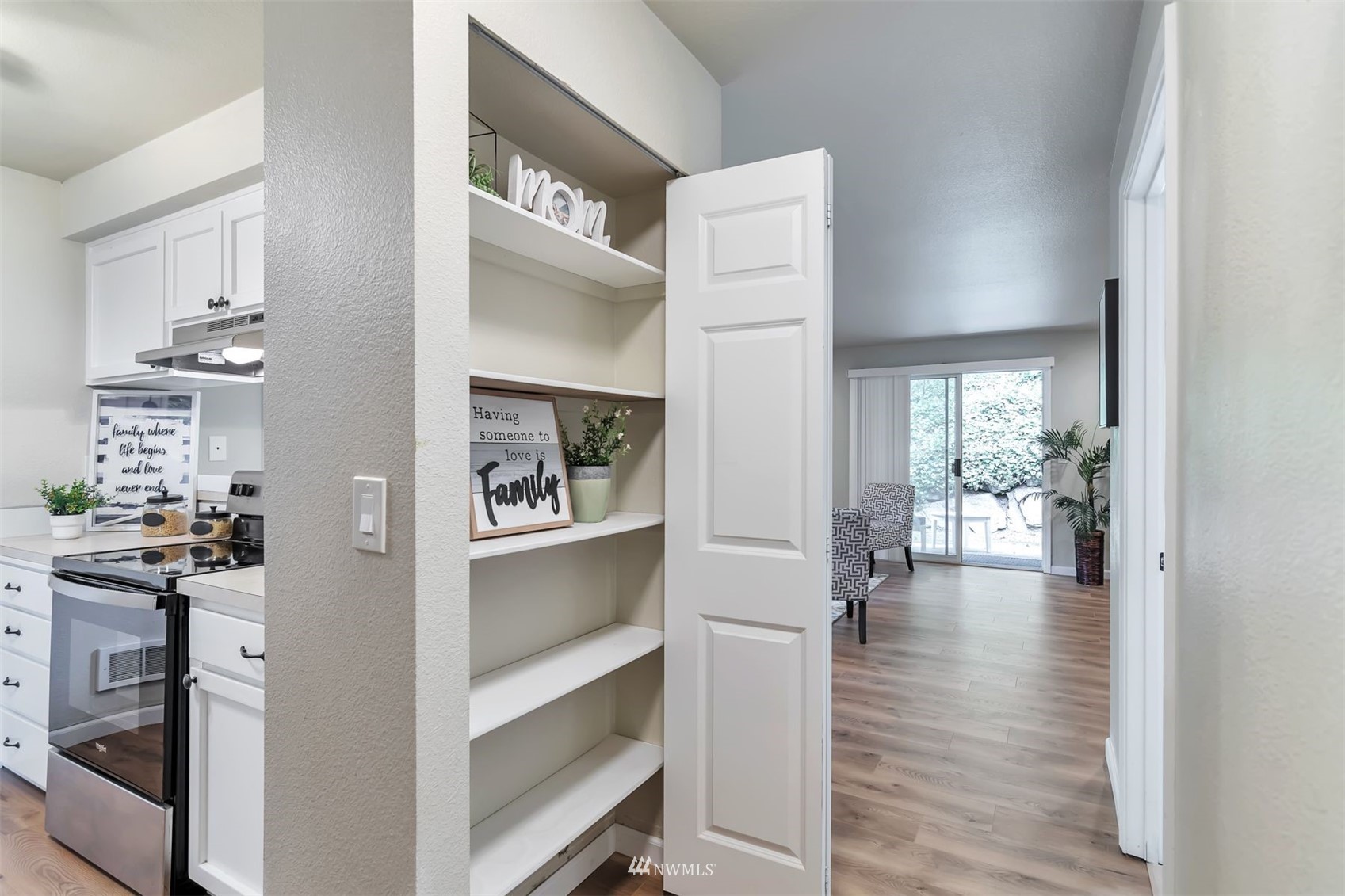 18910 Bothell Everett Highway, Unit O1 Bothell, WA 98012 - Photo 7 of 15 a view of a hallway with wooden floor and a kitchen