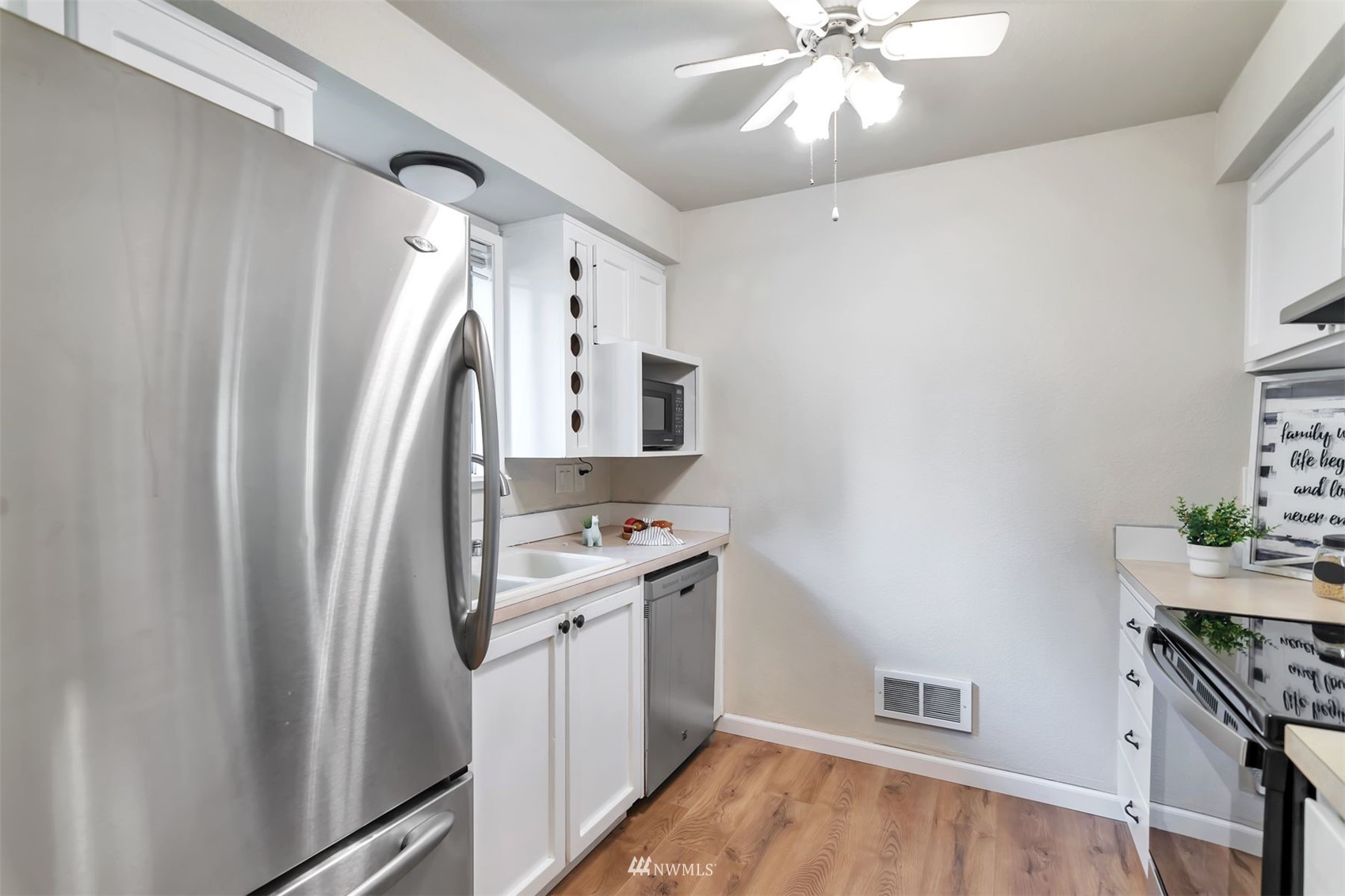 18910 Bothell Everett Highway, Unit O1 Bothell, WA 98012 - Photo 8 of 15 a bathroom with a sink a mirror and a shower
