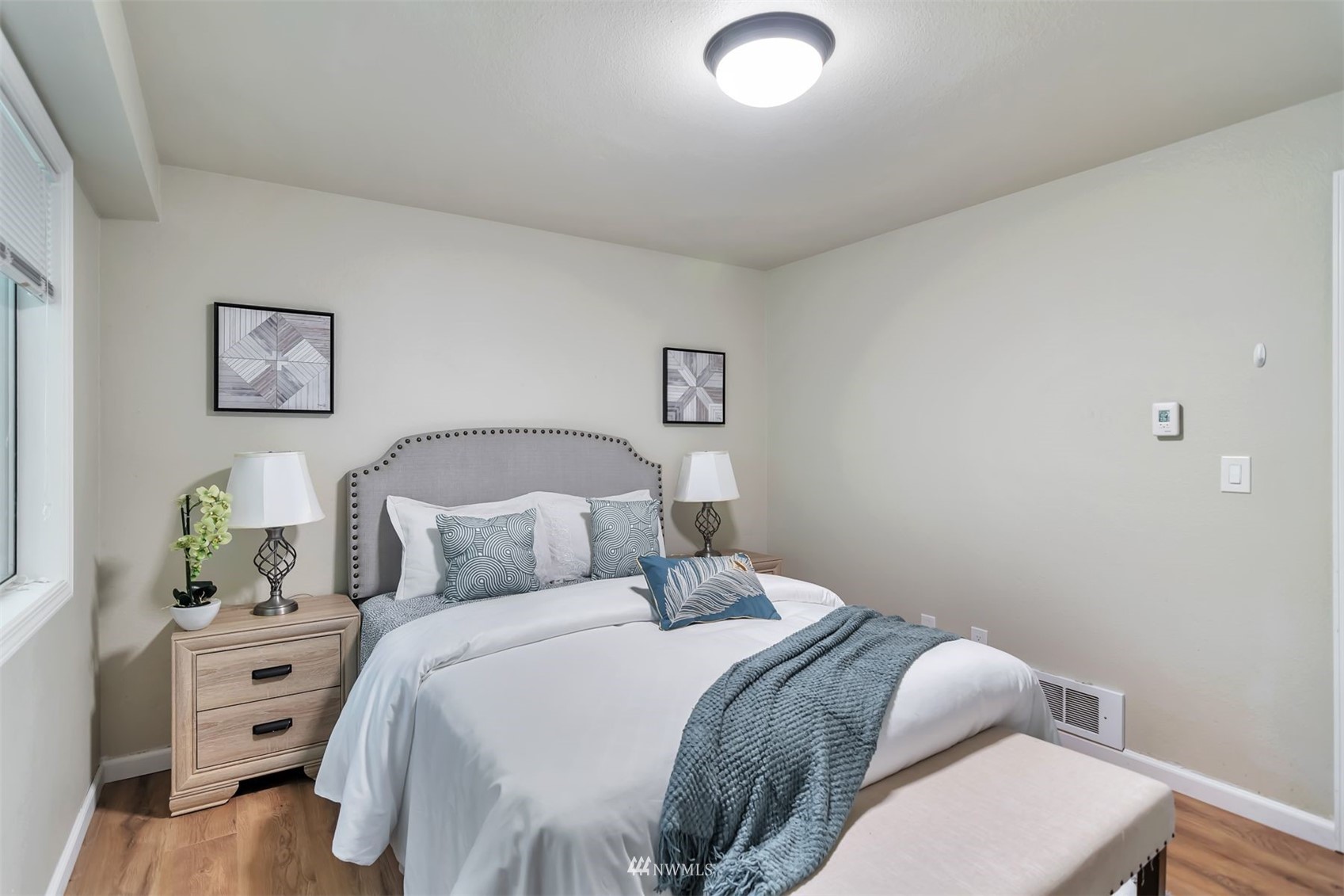 18910 Bothell Everett Highway, Unit O1 Bothell, WA 98012 - Photo 9 of 15 a bedroom with a bed and painting on the wall