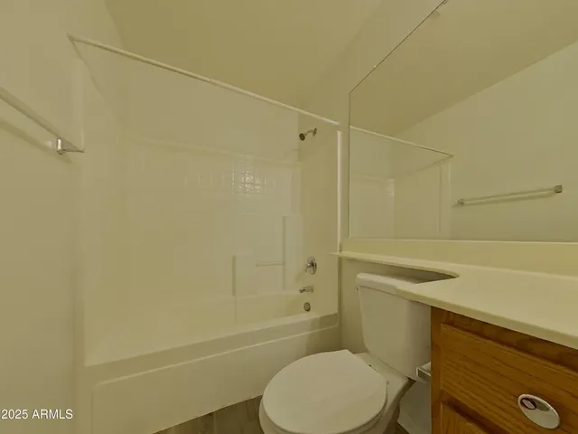 a bathroom with a toilet and shower