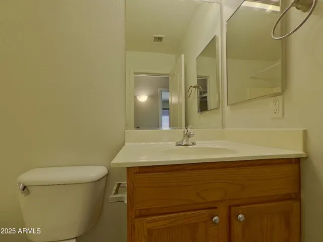 a bathroom with a sink a toilet and a mirror