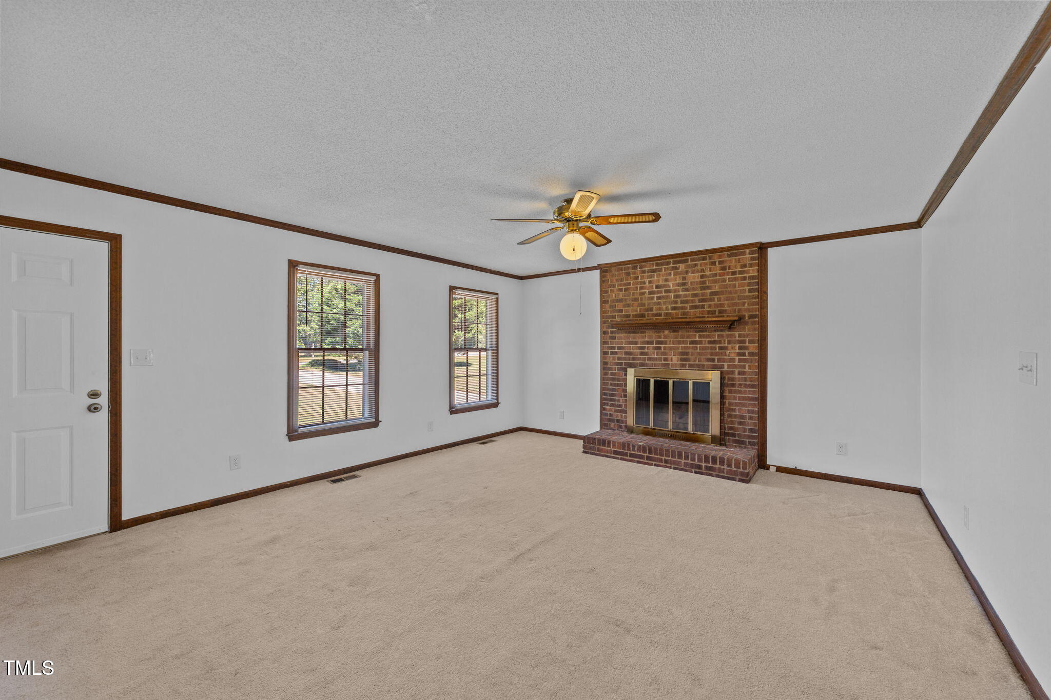 1101 Robinfield Drive Raleigh, NC 27603 - Photo 15 of 48 a view of an empty room with a fireplace and a window