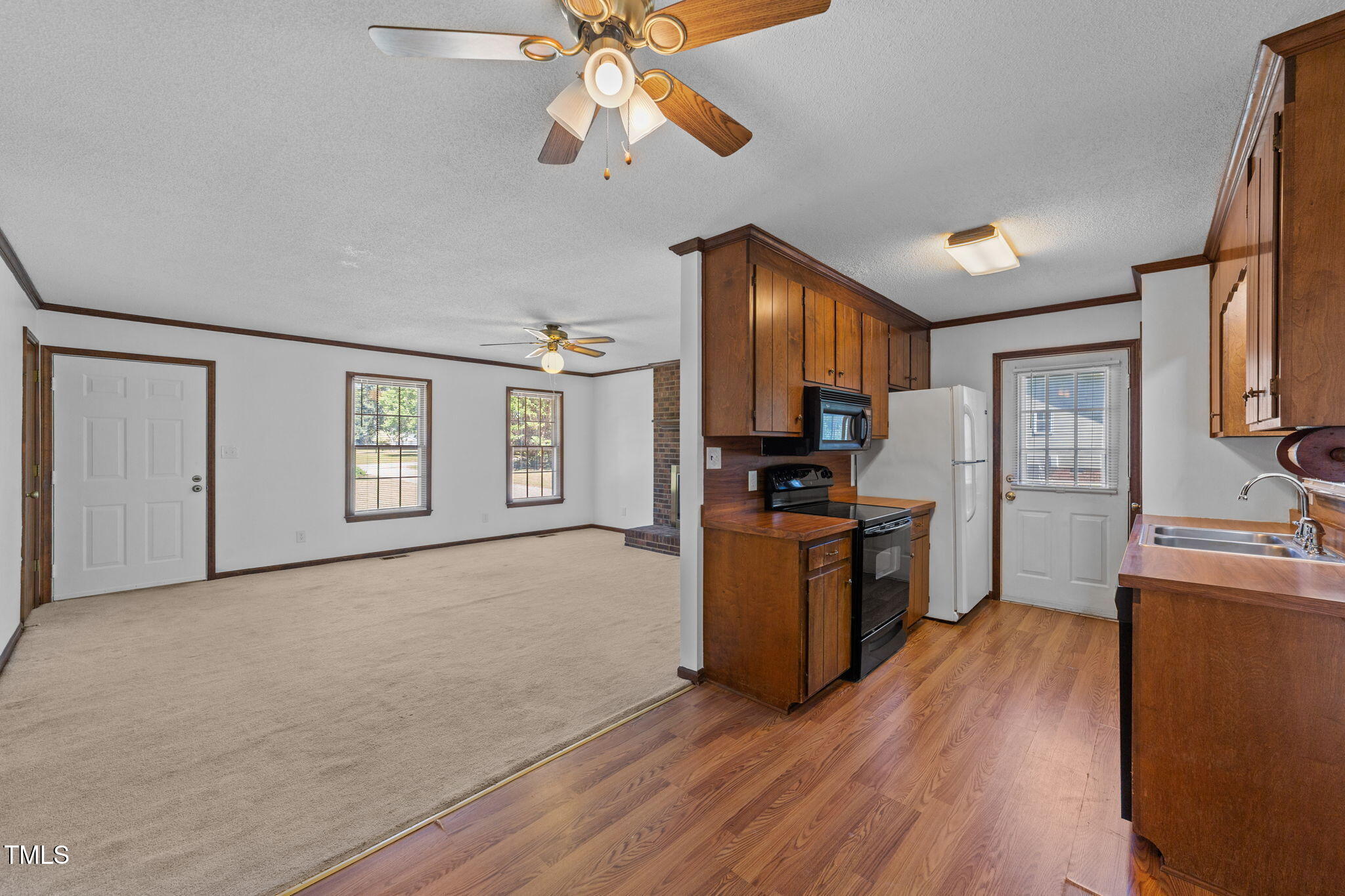 1101 Robinfield Drive Raleigh, NC 27603 - Photo 16 of 48 a kitchen with stainless steel appliances granite countertop a refrigerator a stove top oven a sink dishwasher and wooden floor