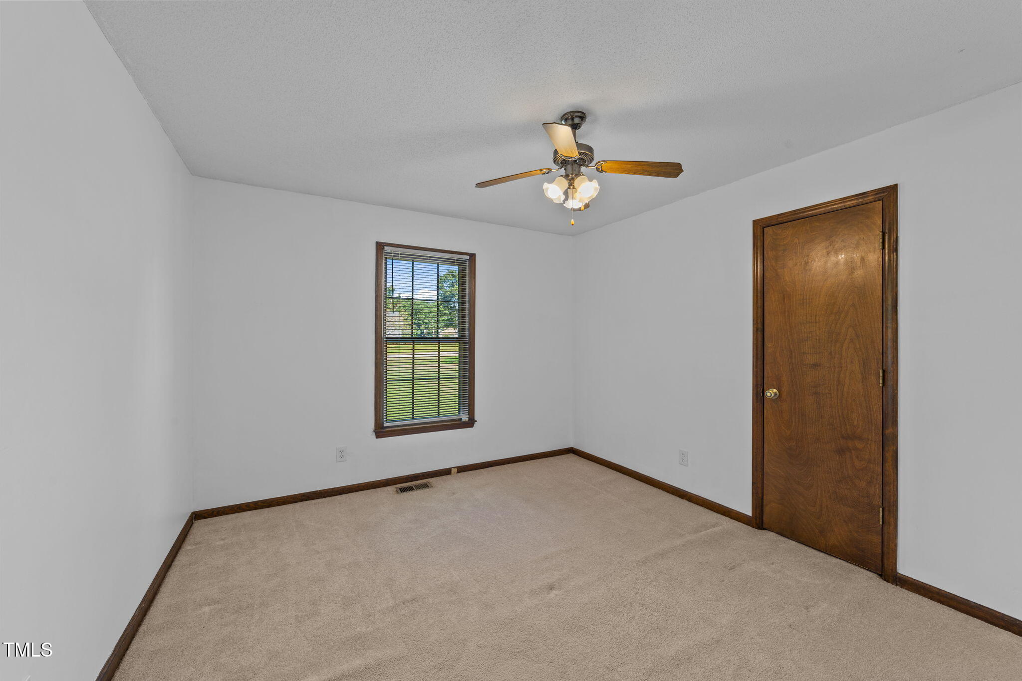 1101 Robinfield Drive Raleigh, NC 27603 - Photo 24 of 48 an empty room with windows and chandelier fan