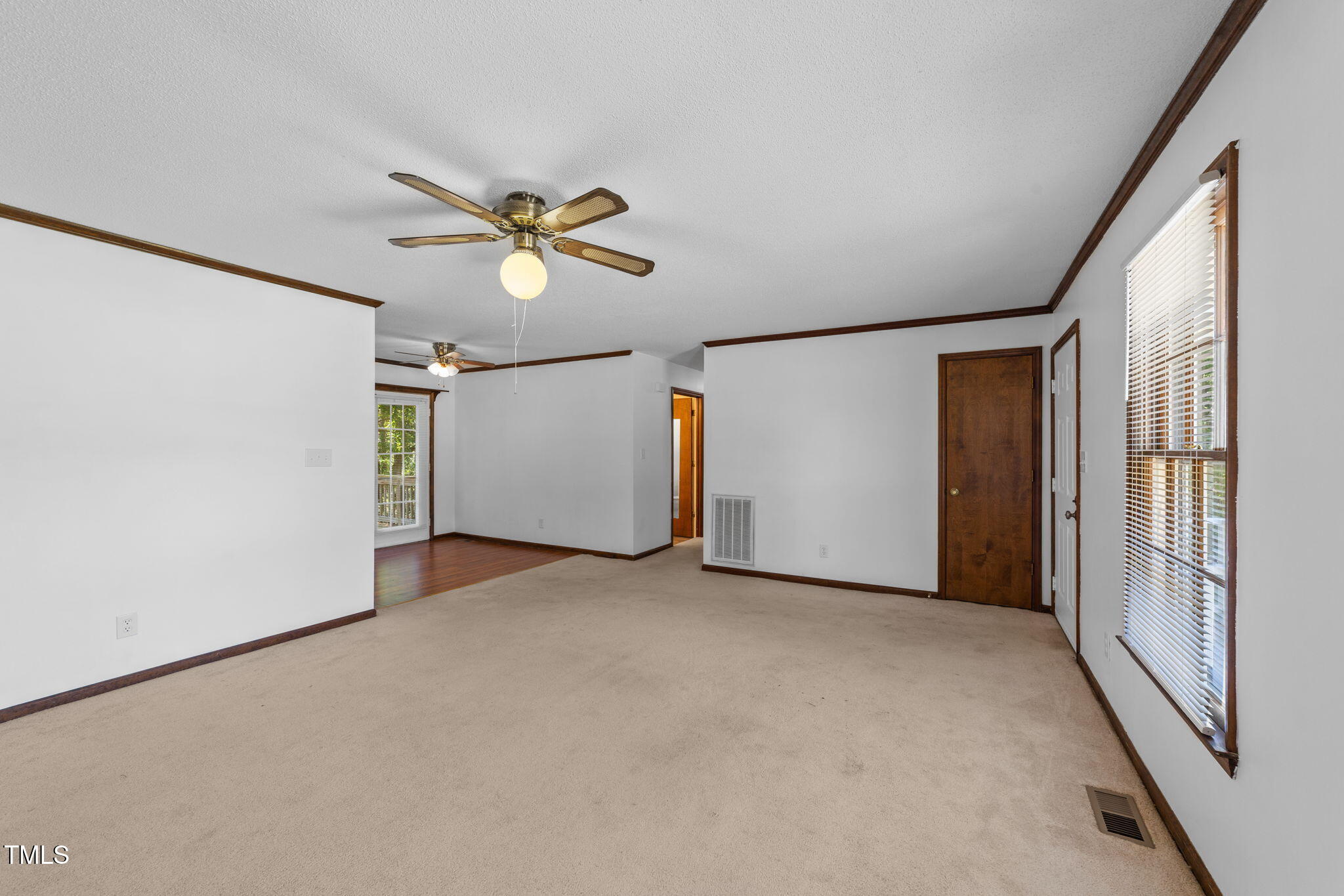 1101 Robinfield Drive Raleigh, NC 27603 - Photo 25 of 48 an empty room with chandelier fan and windows