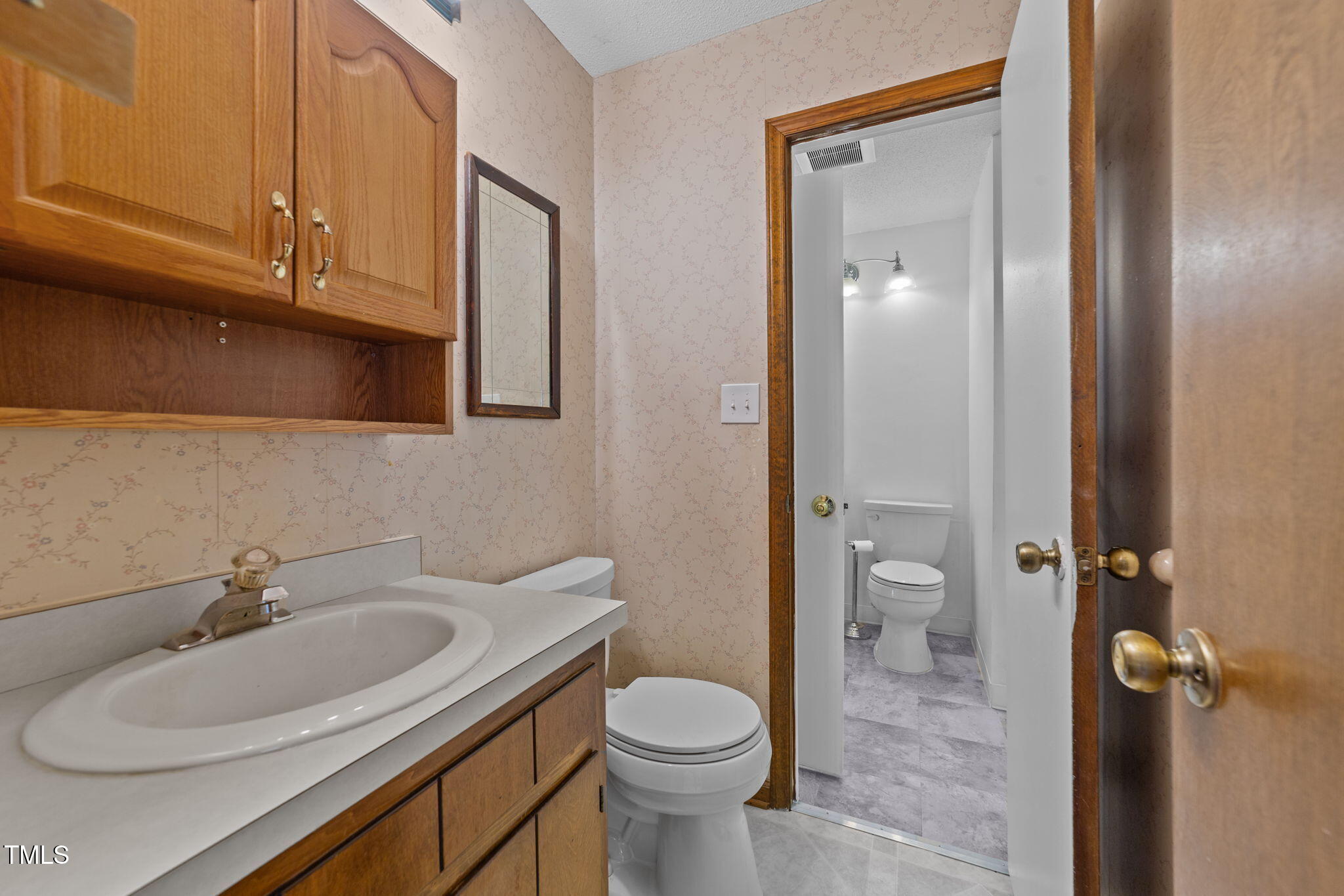 1101 Robinfield Drive Raleigh, NC 27603 - Photo 27 of 48 a bathroom with a sink toilet and shower