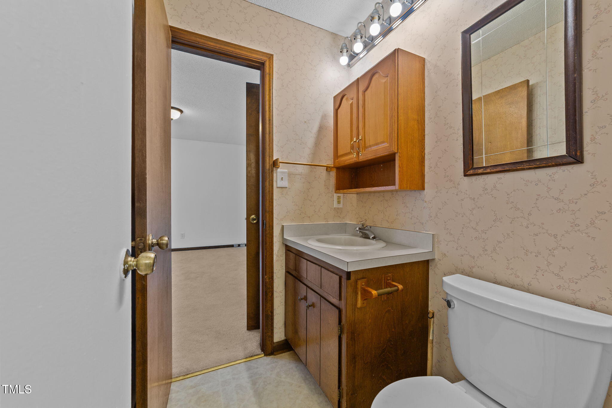 1101 Robinfield Drive Raleigh, NC 27603 - Photo 30 of 48 a bathroom with a sink toilet and mirror