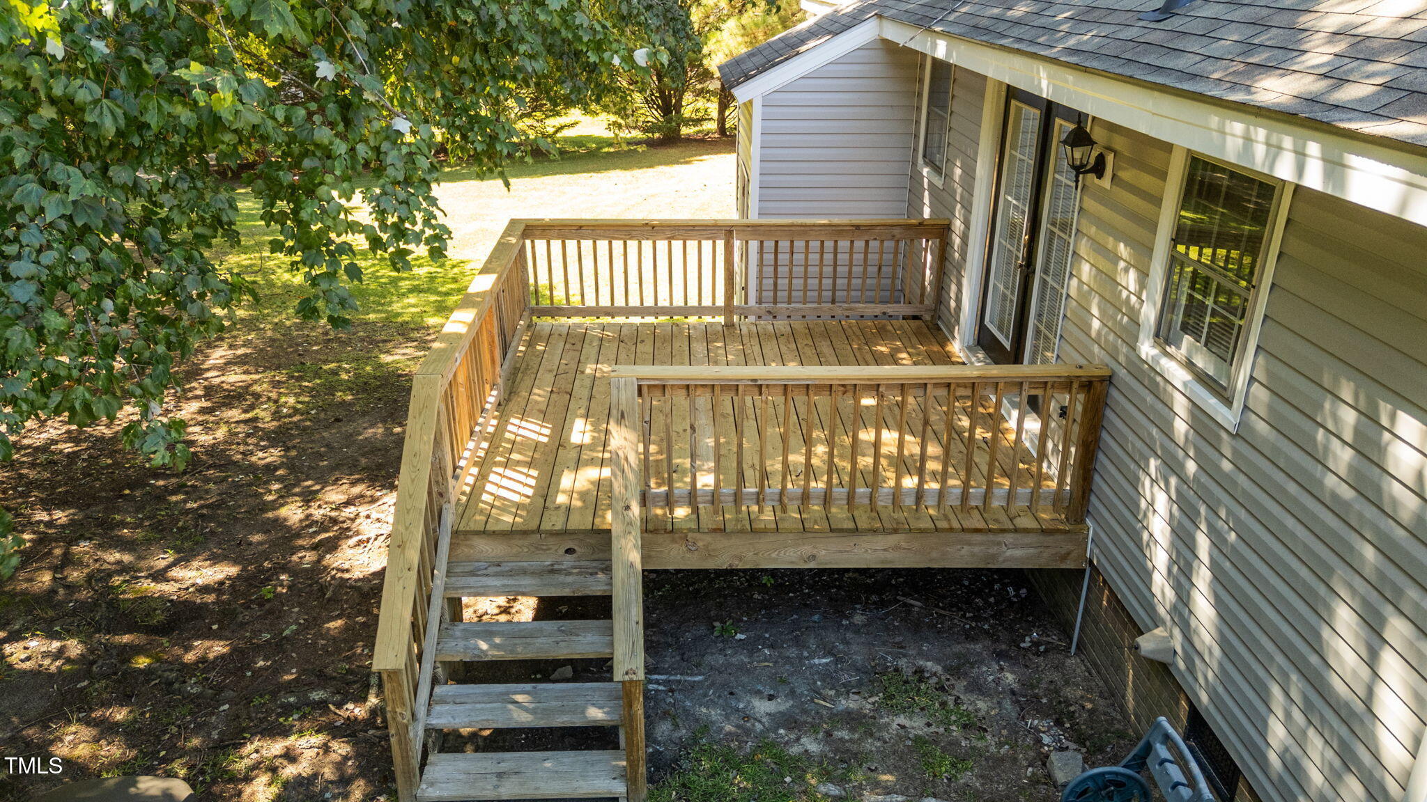 1101 Robinfield Drive Raleigh, NC 27603 - Photo 31 of 48 a view of a wooden door with a bench in the patio