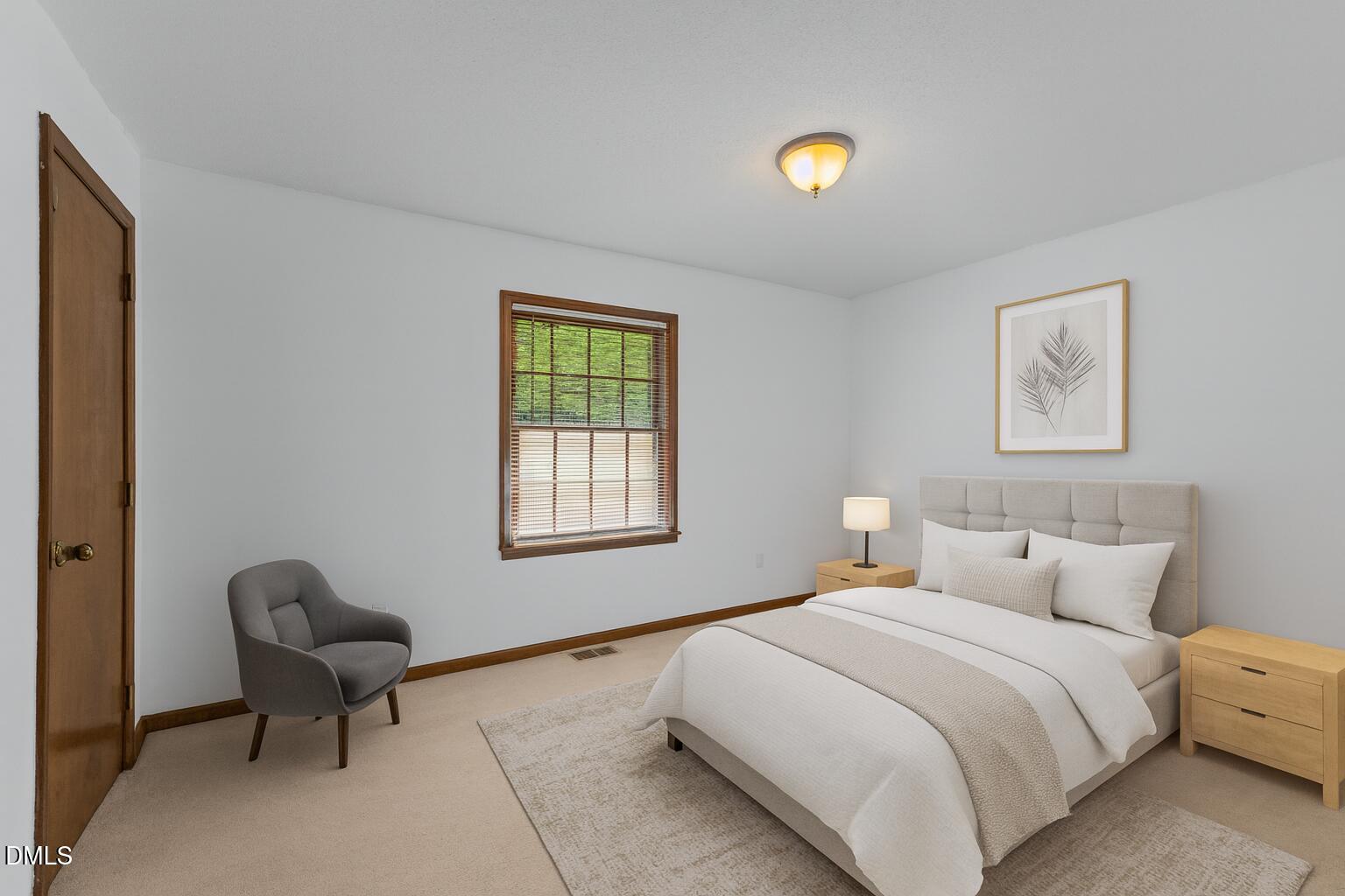 1101 Robinfield Drive Raleigh, NC 27603 - Photo 4 of 48 a bedroom with a bed and a chair