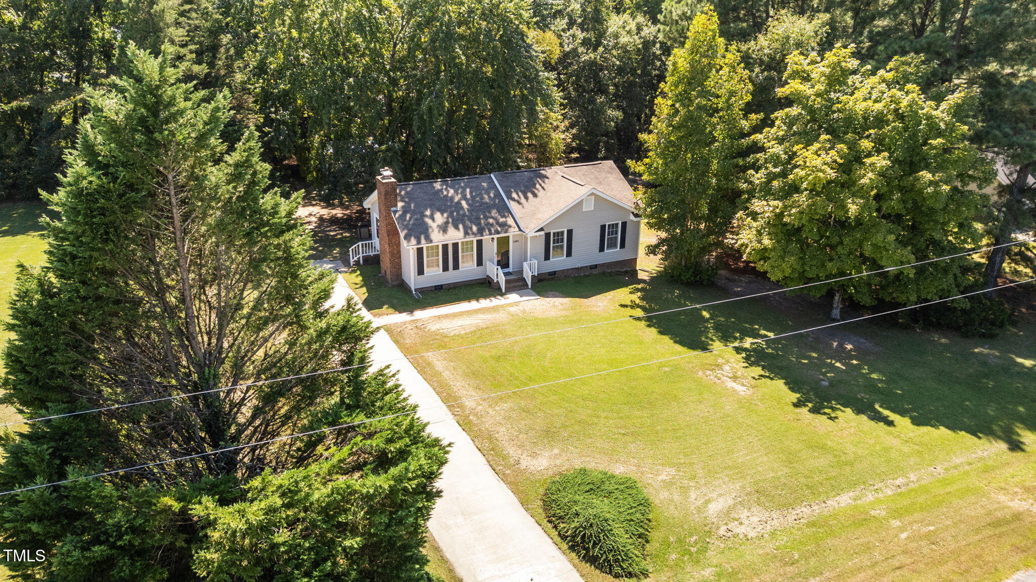 1101 Robinfield Drive Raleigh, NC 27603 - Photo 44 of 48 a view of a house with a yard wooden fence and a large tree