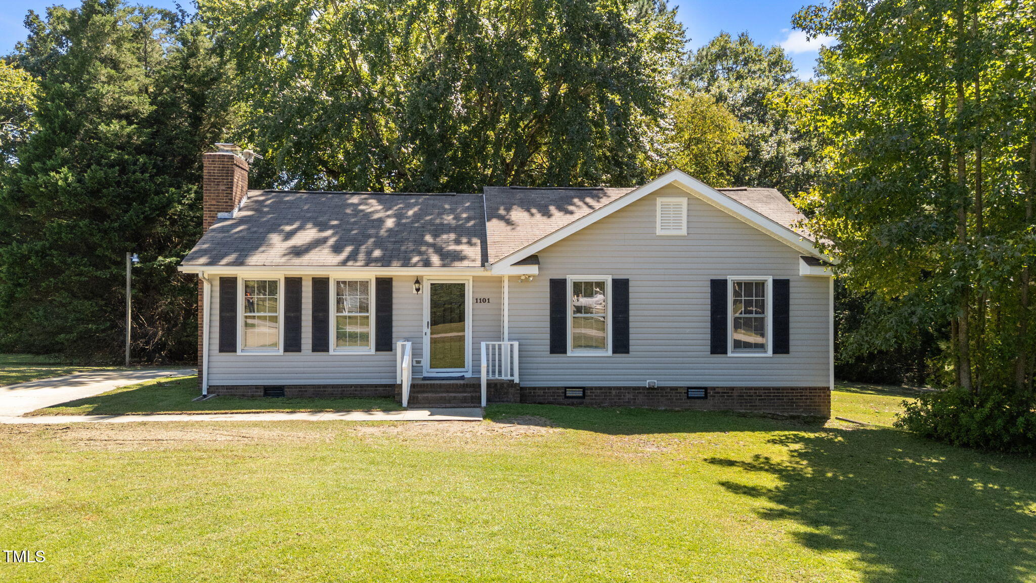 1101 Robinfield Drive Raleigh, NC 27603 - Photo 5 of 48 a front view of a house with a yard balcony