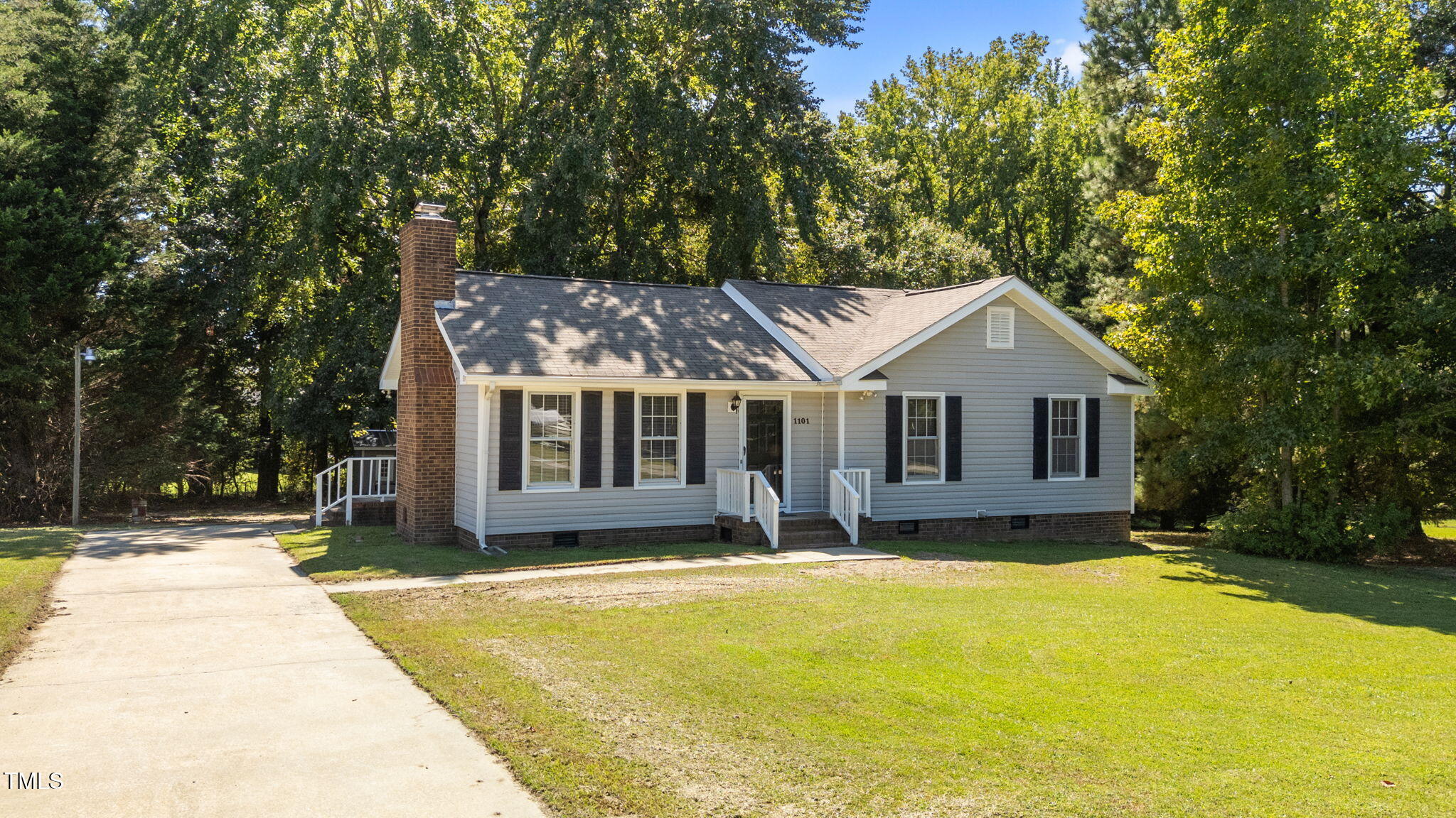 1101 Robinfield Drive Raleigh, NC 27603 - Photo 6 of 48 a front view of a house with a yard