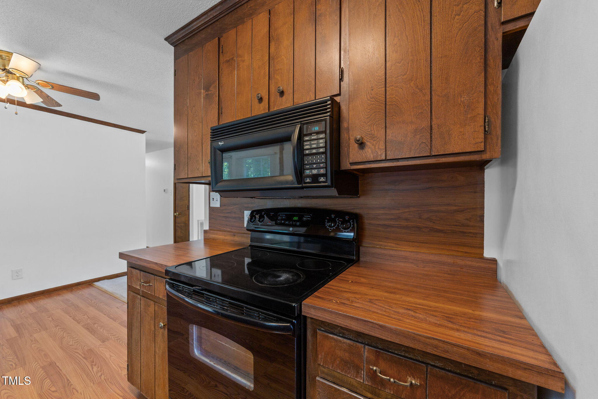1101 Robinfield Drive Raleigh, NC 27603 - Photo 9 of 48 a kitchen with wooden cabinets and a stove top oven