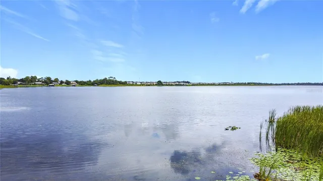 a view of a lake with houses in the back