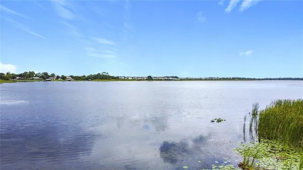 a view of a lake with houses in the back