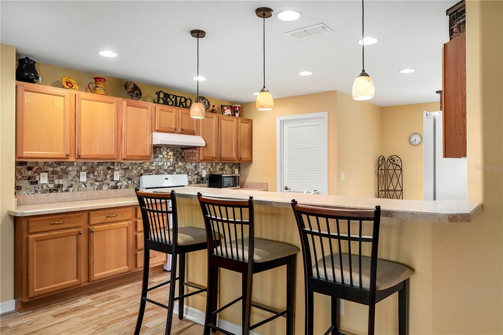 8180 Southwest 80th Terrace Ocala, FL 34476 - Photo 14 of 34 a kitchen with a table chairs sink and cabinets