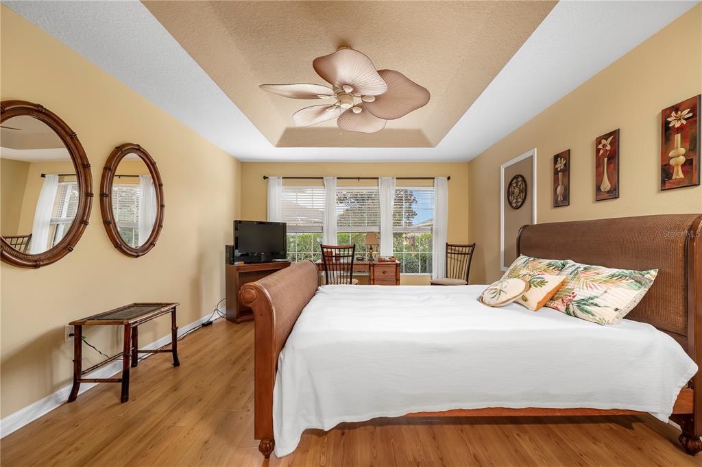 8180 Southwest 80th Terrace Ocala, FL 34476 - Photo 19 of 34 a bedroom with a bed a mirror and a window