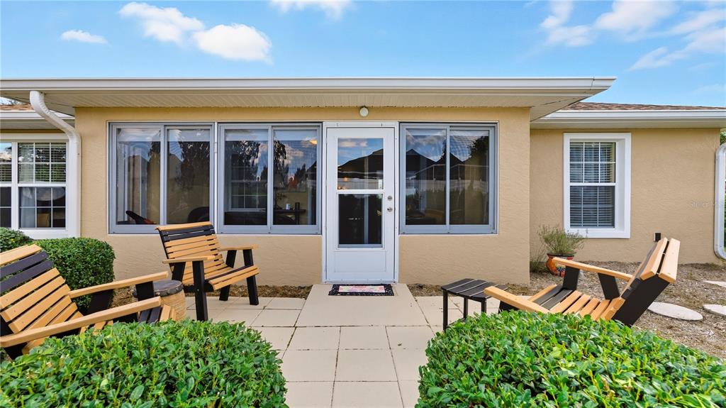 8180 Southwest 80th Terrace Ocala, FL 34476 - Photo 2 of 34 a front view of a house with outdoor seating and large windows