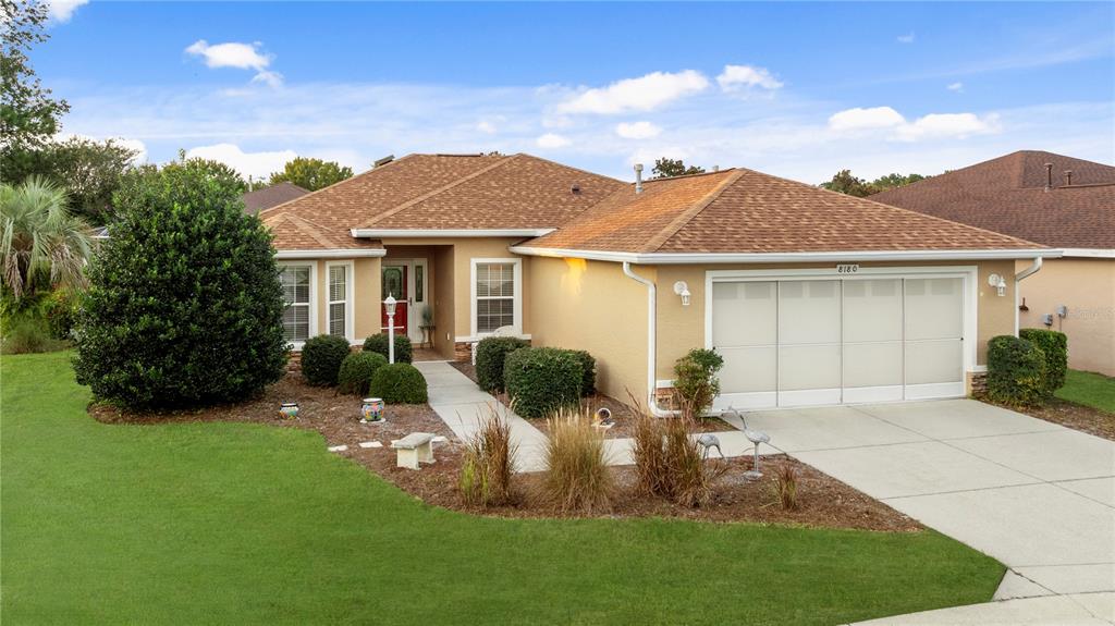 8180 Southwest 80th Terrace Ocala, FL 34476 - Photo 33 of 34 a front view of a house with a garden and plants