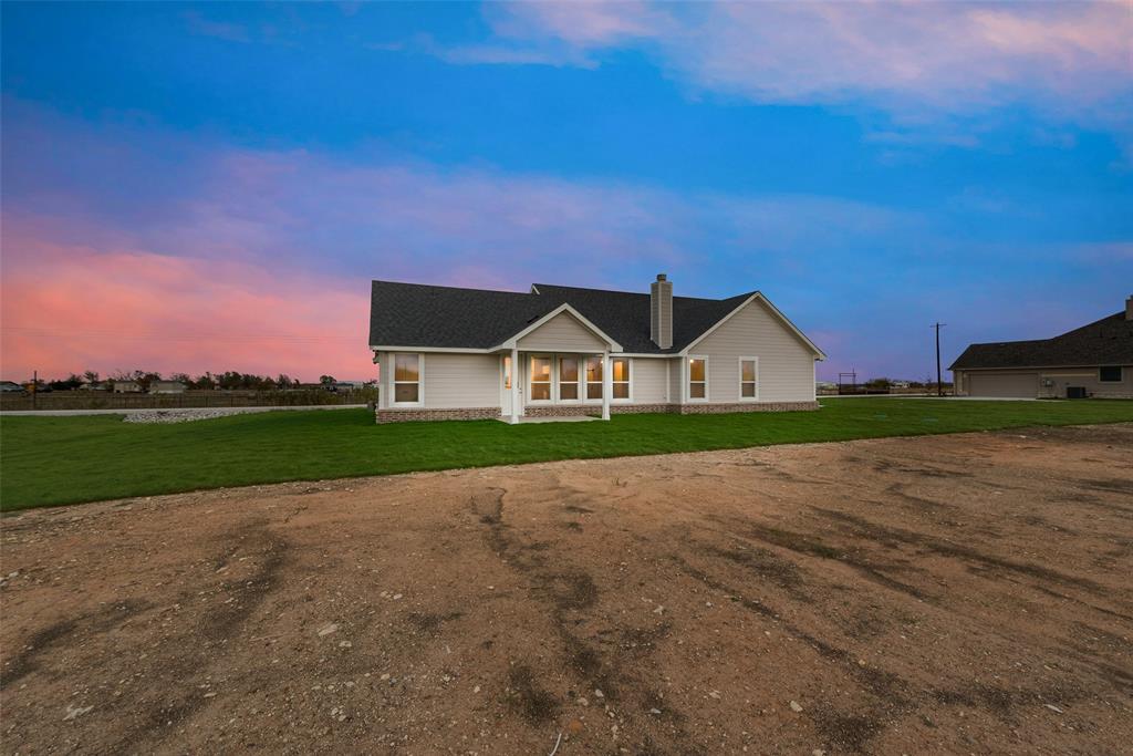 1230 County Road 200 Valley View, TX 76272 - Photo 23 of 26 View of front facade with a lawn and a chimney