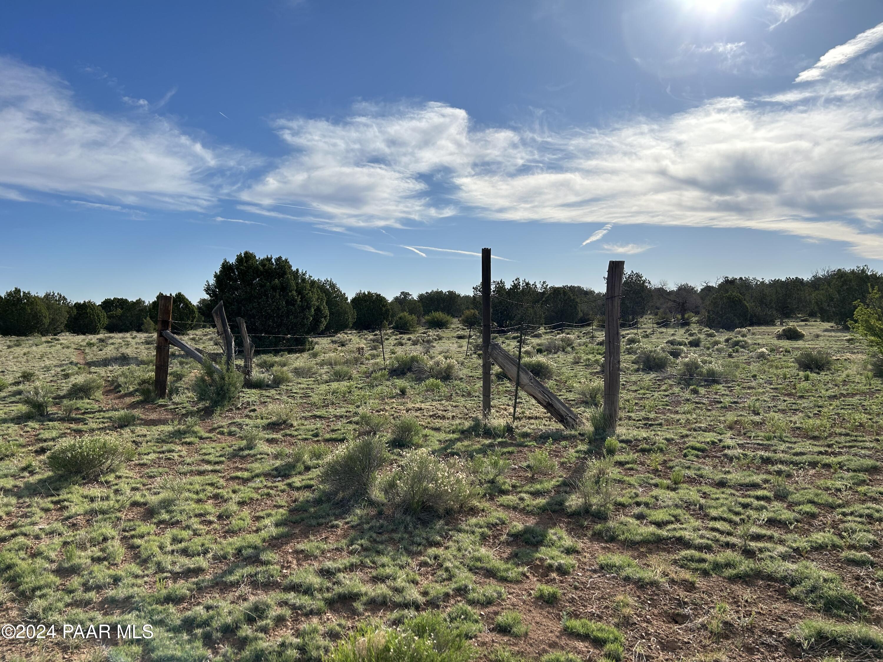 0 Off Pumphouse Road Seligman, AZ 86337 - Photo 1 of 8 a view of a dry yard with wooden fence