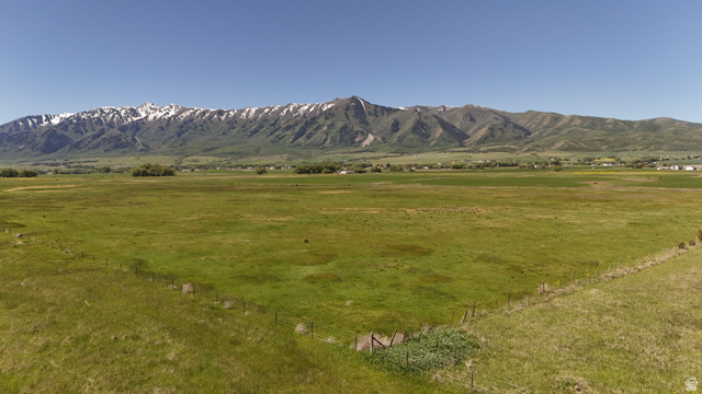 320 South 5400 West Logan, UT 84321 - Photo 16 of 42 Expansive green acreage with distant snow-capped mountains