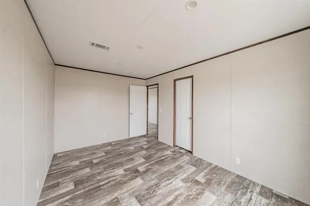 a view of a room with wooden floor