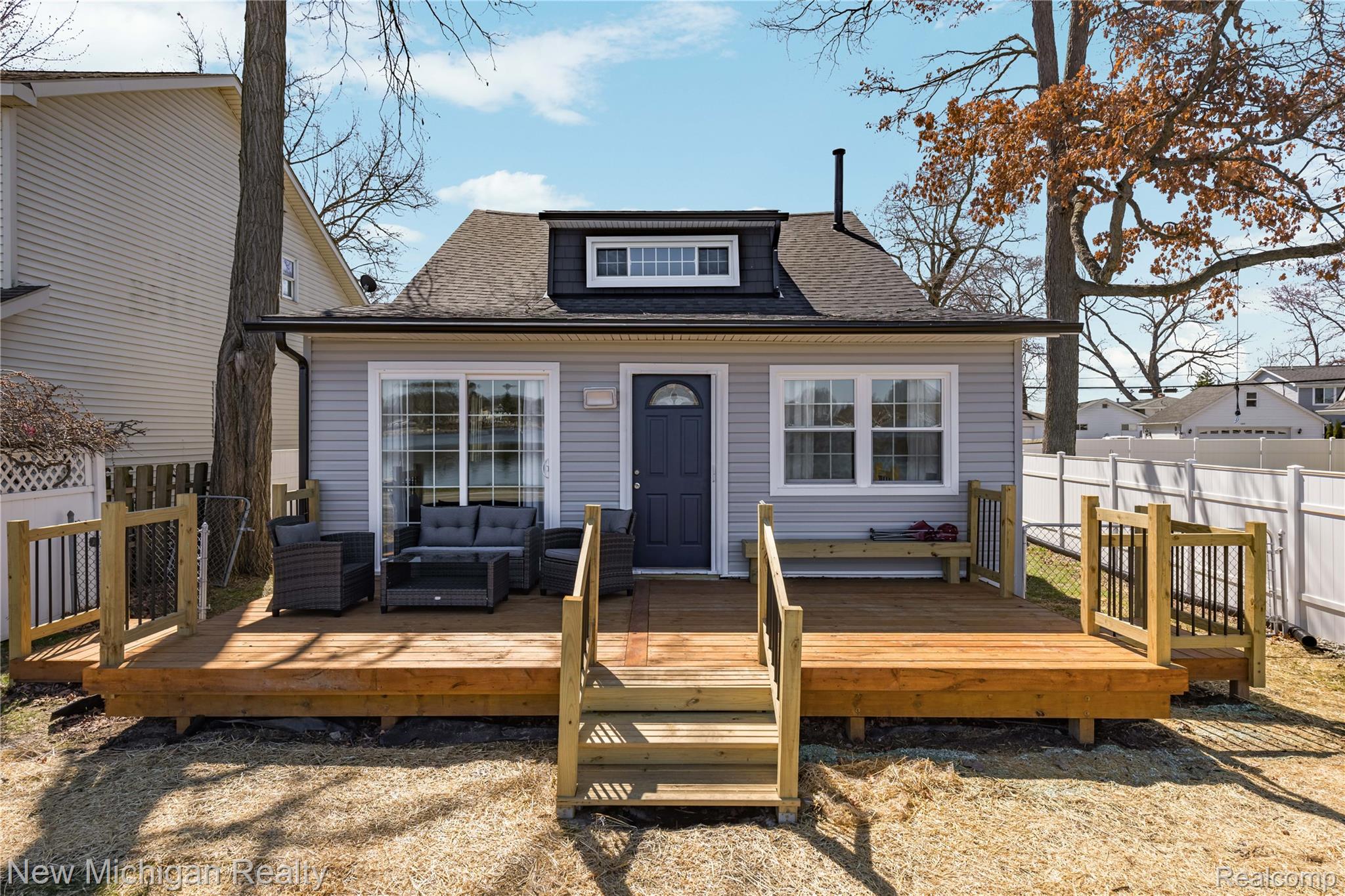 8665 Cooley Lake Road Commerce Township, MI 48382 - Photo 1 of 52 View of front of property with an outdoor living space, a shingled roof, and a wooden deck